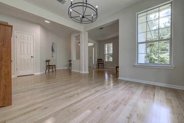 15053 Haley Holw, Austin, TX 78728 - empty room with a chandelier, light wood-type flooring, and baseboards