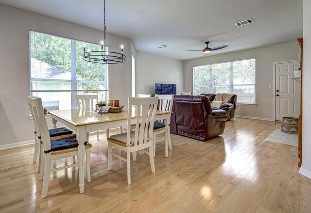 15053 Haley Holw, Austin, TX 78728 - dining space with light wood-type flooring, a chandelier, baseboards, and ceiling fan