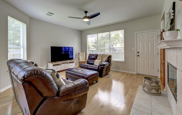 15053 Haley Holw, Austin, TX 78728 - living area with light wood-type flooring, ceiling fan, a fireplace, and baseboards