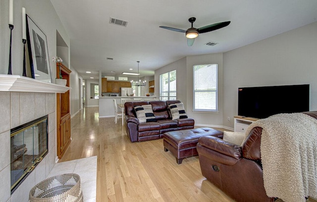 15053 Haley Holw, Austin, TX 78728 - living area with light wood finished floors, ceiling fan, a tile fireplace, recessed lighting, and baseboards
