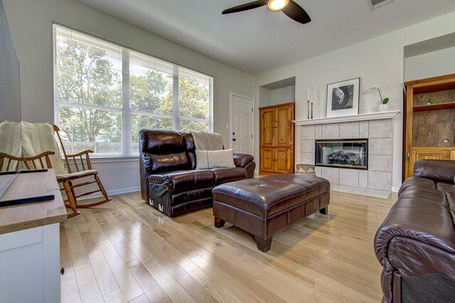 15053 Haley Holw, Austin, TX 78728 - living area with a ceiling fan, light wood finished floors, a fireplace, and baseboards