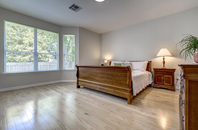 15053 Haley Holw, Austin, TX 78728 - bedroom featuring multiple windows, light wood finished floors, and baseboards