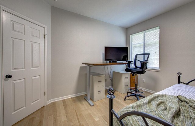 15053 Haley Holw, Austin, TX 78728 - bedroom with light wood finished floors, baseboards, and a desk