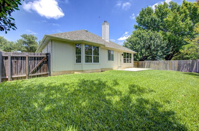 15053 Haley Holw, Austin, TX 78728 - rear view of house featuring a chimney, a patio, and roof with shingles