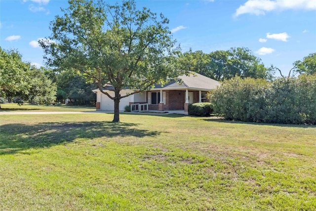 201 Murchison Dr, Cedar Creek, TX 78612 - view of front of house with concrete driveway, a front yard, a garage, brick siding, and a porch