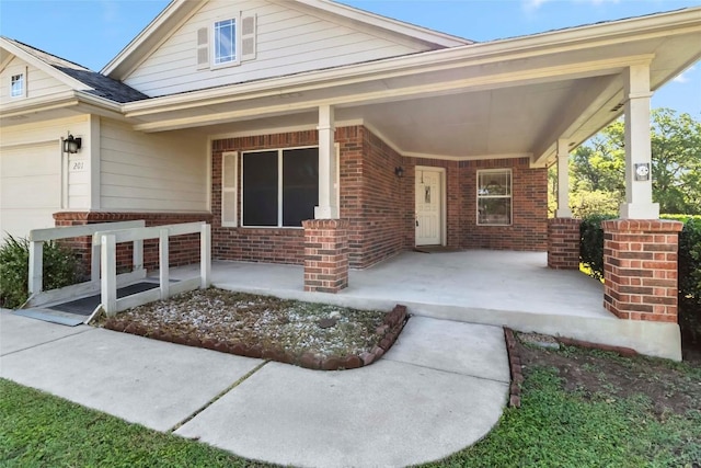 201 Murchison Dr, Cedar Creek, TX 78612 - view of front of property with brick siding, covered porch, and a garage