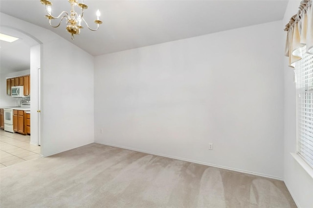 201 Murchison Dr, Cedar Creek, TX 78612 - unfurnished dining area with arched walkways, light colored carpet, healthy amount of natural light, and a chandelier