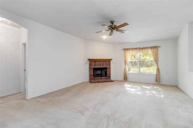 201 Murchison Dr, Cedar Creek, TX 78612 - unfurnished living room with ceiling fan, carpet flooring, a fireplace, and arched walkways