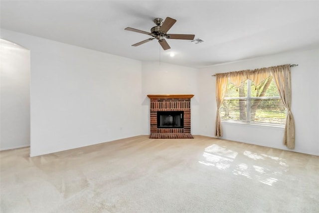 201 Murchison Dr, Cedar Creek, TX 78612 - unfurnished living room featuring ceiling fan, carpet, a brick fireplace, and arched walkways