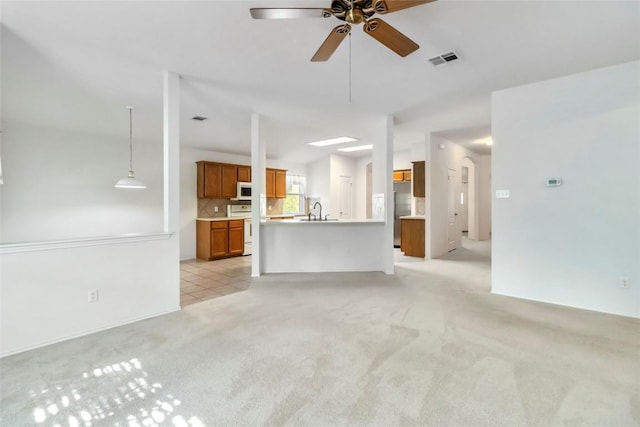 201 Murchison Dr, Cedar Creek, TX 78612 - unfurnished living room with a ceiling fan, light colored carpet, and a sink