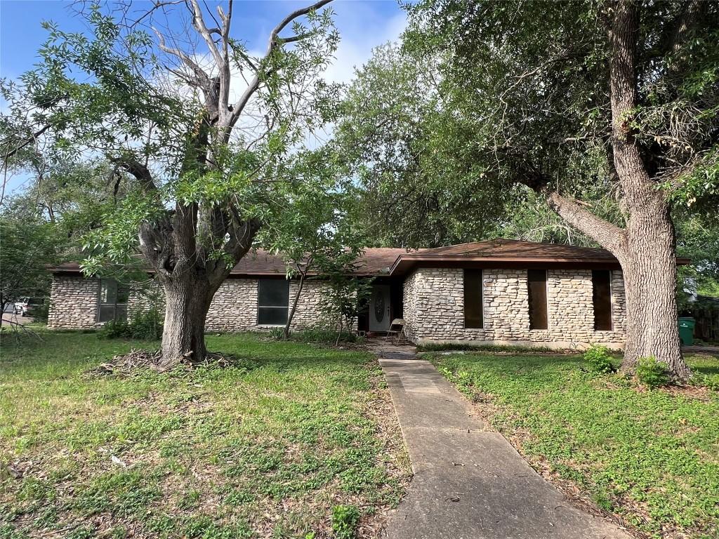 2201 Bel Air Dr, Taylor, TX 76574 - view of front of property with stone siding and a front lawn
