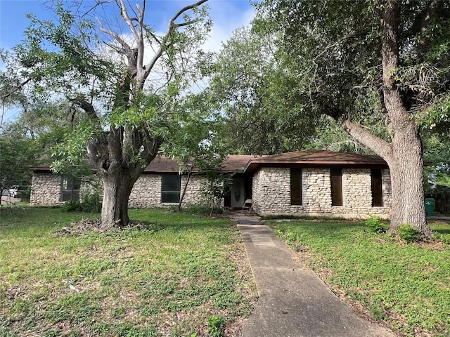 2201 Bel Air Dr, Taylor, TX 76574 - view of front of house with stone siding and a front lawn