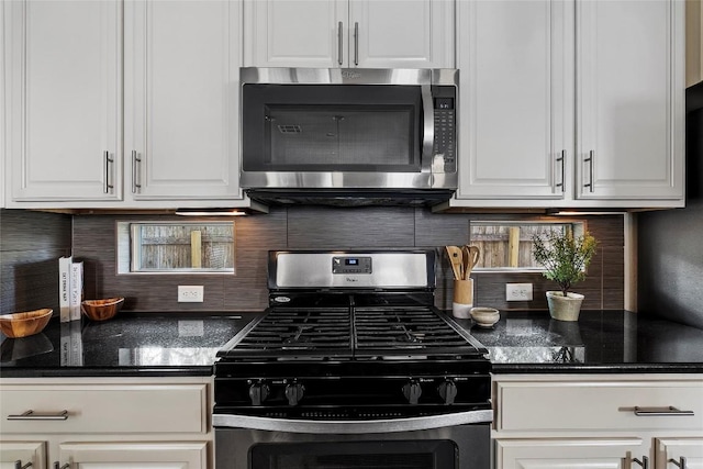 7709 Menchaca Rd Unit 14, Austin, TX 78745 - kitchen featuring stainless steel appliances, white cabinetry, and decorative backsplash