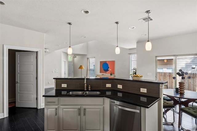 7709 Menchaca Rd Unit 14, Austin, TX 78745 - kitchen with stainless steel dishwasher, dark wood finished floors, dark countertops, pendant lighting, and recessed lighting