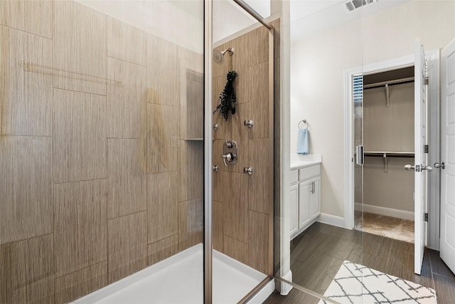 7709 Menchaca Rd Unit 14, Austin, TX 78745 - bathroom with a stall shower, a spacious closet, and vanity