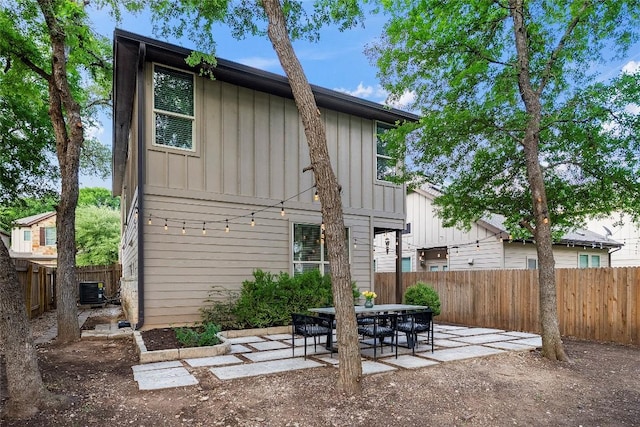 7709 Menchaca Rd Unit 14, Austin, TX 78745 - rear view of house with board and batten siding, a patio area, and a fenced backyard