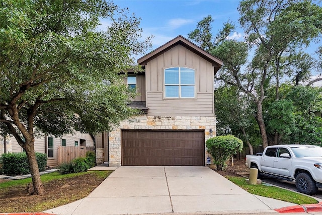 7709 Menchaca Rd Unit 14, Austin, TX 78745 - view of front of property featuring stone siding, board and batten siding, an attached garage, and concrete driveway