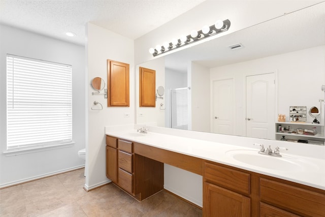 2105 Zeppelin Dr, Cedar Park, TX 78613 - bathroom with double vanity, tile patterned flooring, and a textured ceiling