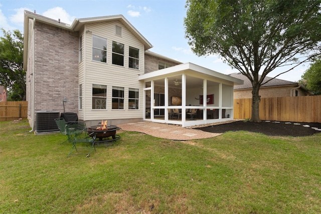2105 Zeppelin Dr, Cedar Park, TX 78613 - rear view of house featuring cooling unit, a fire pit, a sunroom, and brick siding
