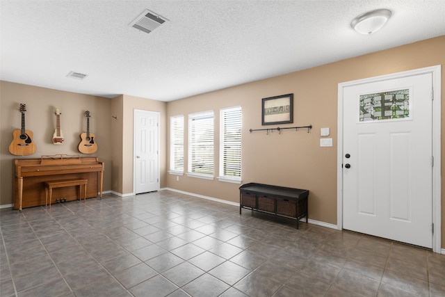 2105 Zeppelin Dr, Cedar Park, TX 78613 - tiled entrance foyer with a textured ceiling and baseboards