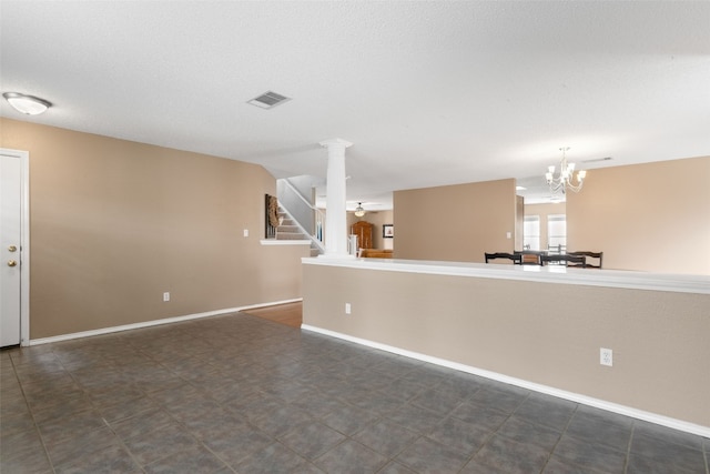 2105 Zeppelin Dr, Cedar Park, TX 78613 - unfurnished living room with a chandelier, stairway, baseboards, and ornate columns
