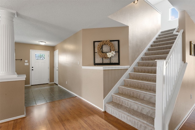 2105 Zeppelin Dr, Cedar Park, TX 78613 - entryway with decorative columns, stairs, wood finished floors, a textured ceiling, and baseboards