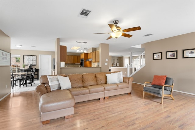 2105 Zeppelin Dr, Cedar Park, TX 78613 - living room with light wood-style flooring, stairs, and a ceiling fan