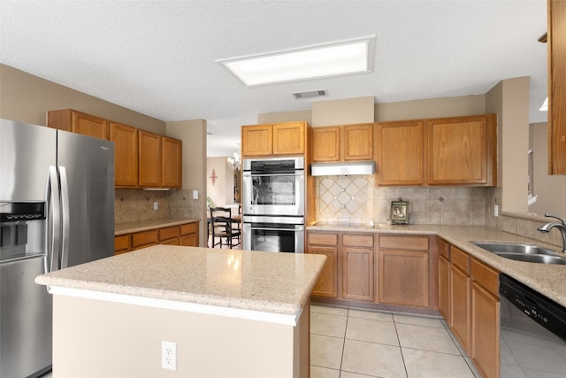 2105 Zeppelin Dr, Cedar Park, TX 78613 - kitchen with stainless steel appliances, a sink, backsplash, a kitchen island, and light tile patterned flooring