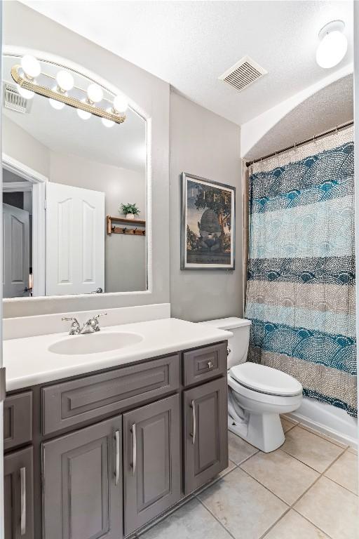 102 Cheerful Ct, Lakeway, TX 78734 - full bathroom with vanity, tile patterned flooring, toilet, and a shower with shower curtain