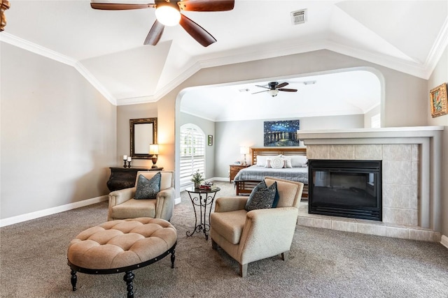 102 Cheerful Ct, Lakeway, TX 78734 - bedroom with carpet flooring, arched walkways, vaulted ceiling, baseboards, and a tiled fireplace