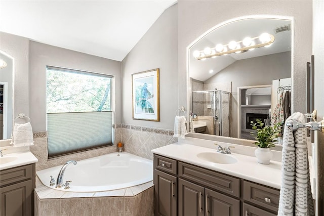 102 Cheerful Ct, Lakeway, TX 78734 - bathroom with vaulted ceiling, two vanities, a shower stall, and a garden tub