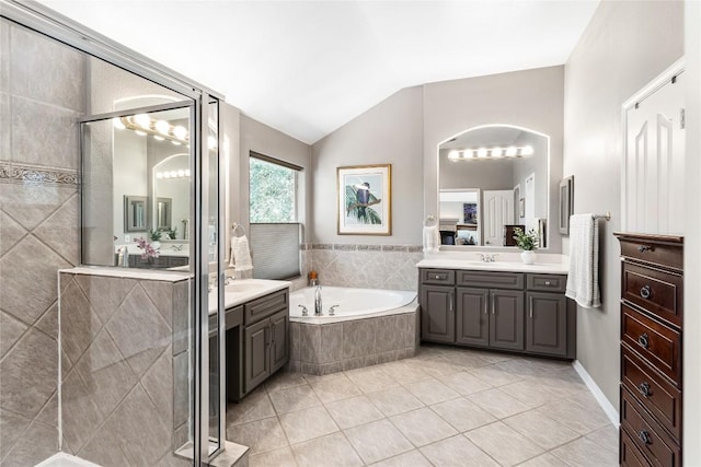 102 Cheerful Ct, Lakeway, TX 78734 - bathroom with two vanities, a garden tub, tile patterned floors, a stall shower, and vaulted ceiling