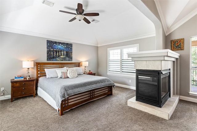 102 Cheerful Ct, Lakeway, TX 78734 - carpeted bedroom with lofted ceiling, a tiled fireplace, baseboards, crown molding, and a ceiling fan