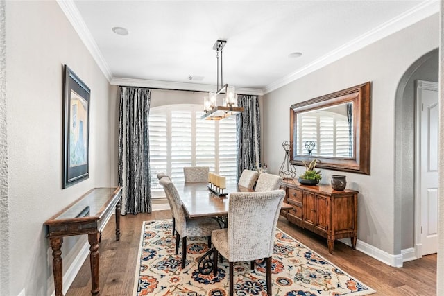 102 Cheerful Ct, Lakeway, TX 78734 - dining room with arched walkways, wood finished floors, ornamental molding, plenty of natural light, and a chandelier