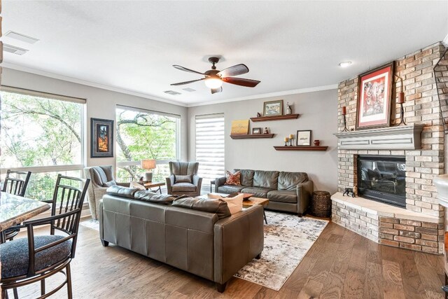 102 Cheerful Ct, Lakeway, TX 78734 - living area with ornamental molding, ceiling fan, a fireplace, and light wood finished floors