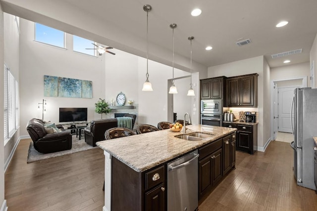 143 Pink Granite Blvd, Dripping Springs, TX 78620 - kitchen with a sink, appliances with stainless steel finishes, open floor plan, a ceiling fan, and dark brown cabinets