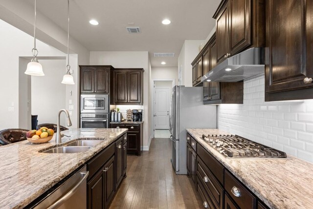 143 Pink Granite Blvd, Dripping Springs, TX 78620 - kitchen with a sink, appliances with stainless steel finishes, exhaust hood, dark brown cabinets, and tasteful backsplash