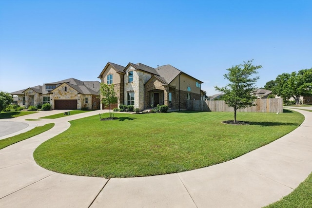 143 Pink Granite Blvd, Dripping Springs, TX 78620 - french country inspired facade featuring stone siding, curved driveway, a residential view, and a garage