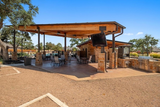 143 Pink Granite Blvd, Dripping Springs, TX 78620 - view of patio with exterior kitchen and outdoor dining area