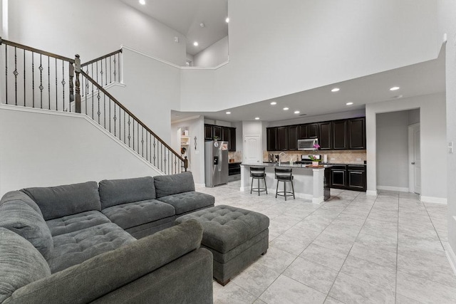 13911 Tribeca, San Antonio, TX 78245 - living room with recessed lighting, a high ceiling, stairs, and baseboards