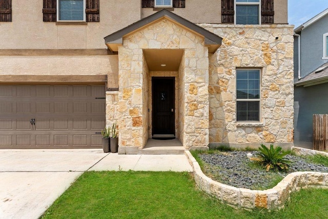 13911 Tribeca, San Antonio, TX 78245 - doorway to property featuring stone siding, a garage, concrete driveway, and stucco siding