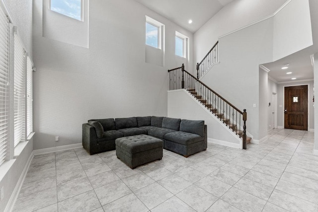 13911 Tribeca, San Antonio, TX 78245 - living room featuring a high ceiling, stairway, recessed lighting, light tile patterned floors, and baseboards