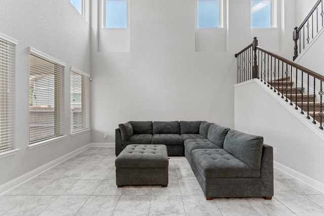 13911 Tribeca, San Antonio, TX 78245 - living room featuring a high ceiling, stairs, baseboards, and light tile patterned flooring