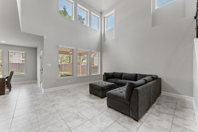 13911 Tribeca, San Antonio, TX 78245 - living room with plenty of natural light, light tile patterned floors, baseboards, and a towering ceiling