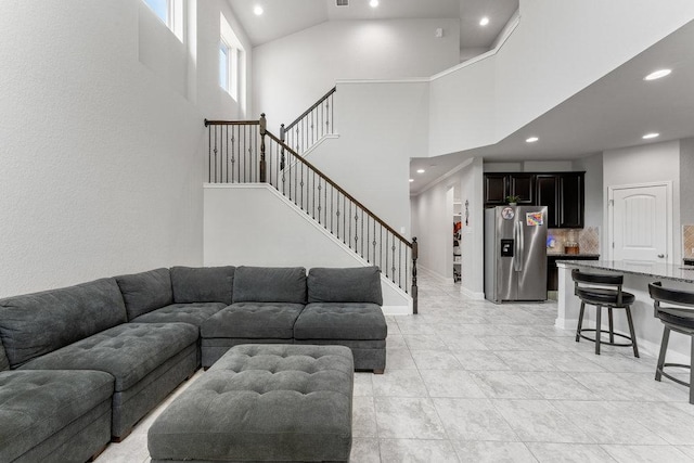13911 Tribeca, San Antonio, TX 78245 - living room with recessed lighting, a towering ceiling, stairway, and light tile patterned flooring
