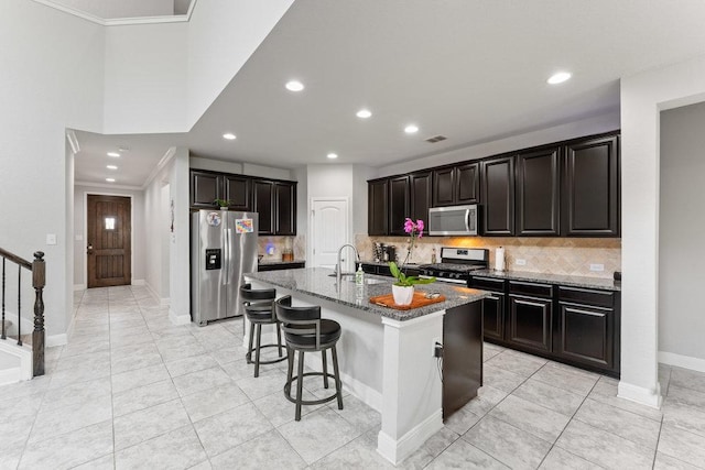 13911 Tribeca, San Antonio, TX 78245 - kitchen with stainless steel appliances, decorative backsplash, recessed lighting, a breakfast bar, and light tile patterned floors