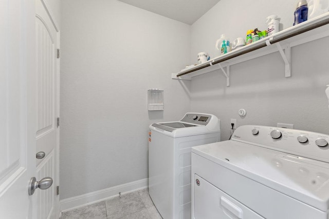 13911 Tribeca, San Antonio, TX 78245 - washroom with washing machine and dryer, baseboards, and light tile patterned floors