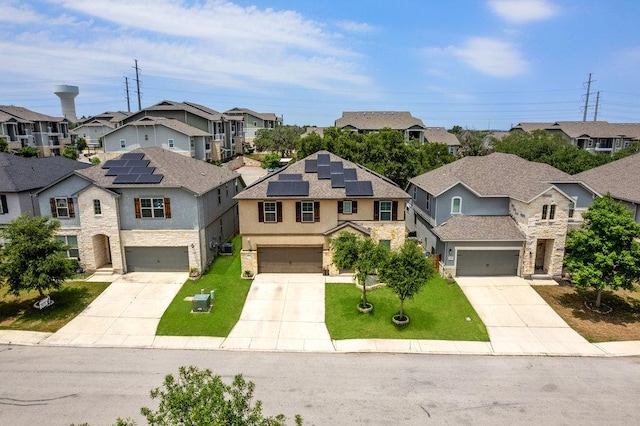 13911 Tribeca, San Antonio, TX 78245 - view of front of property with a residential view, concrete driveway, roof mounted solar panels, and a front lawn