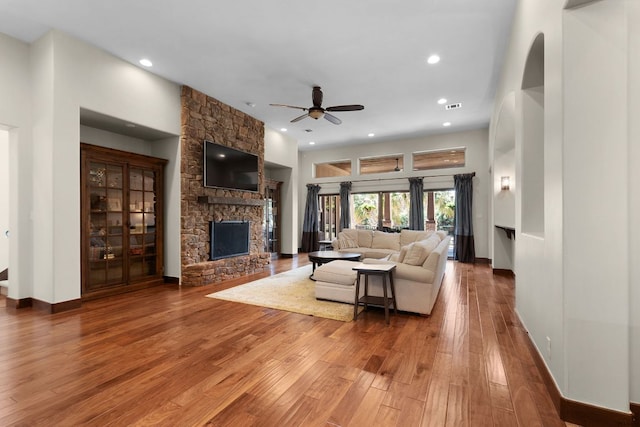 2904 Kodiak Cv, Cedar Park, TX 78613 - living area featuring a ceiling fan, a stone fireplace, hardwood / wood-style floors, recessed lighting, and baseboards