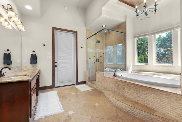 2904 Kodiak Cv, Cedar Park, TX 78613 - bathroom featuring a chandelier, vanity, a garden tub, tile patterned floors, and a shower stall